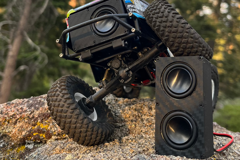 The Double propped on granite in front of a black comp crawler, pine forest behind. 1/24, 1/18 and 1/10 scale.