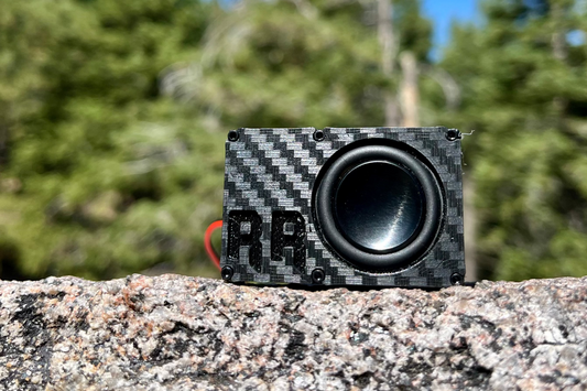 The Single square to the camera on a granite ledge, black driver and RR logo, forest in the background. 1/24 and 1/18 scale.