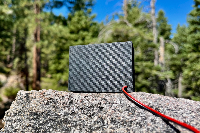 The Super Single from behind on granite, showing the plain rear panel and the red and black receiver lead. 1/10 scale.