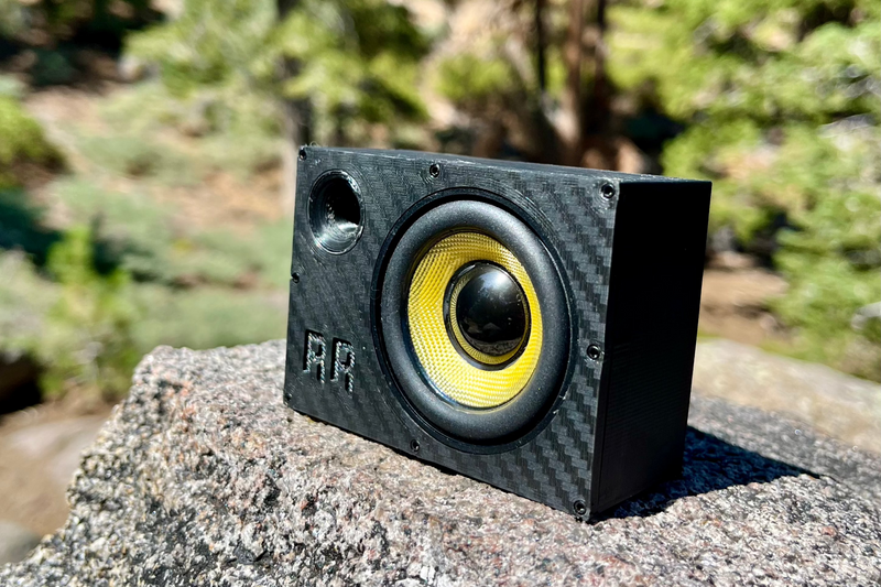 The Supreme Single at three-quarters on granite, yellow cone and the full depth of the enclosure in view. 1/10 scale.