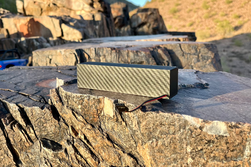 The Quad from behind on a rock ledge, carbon-look weave along the back of the bar. 1/10 scale.