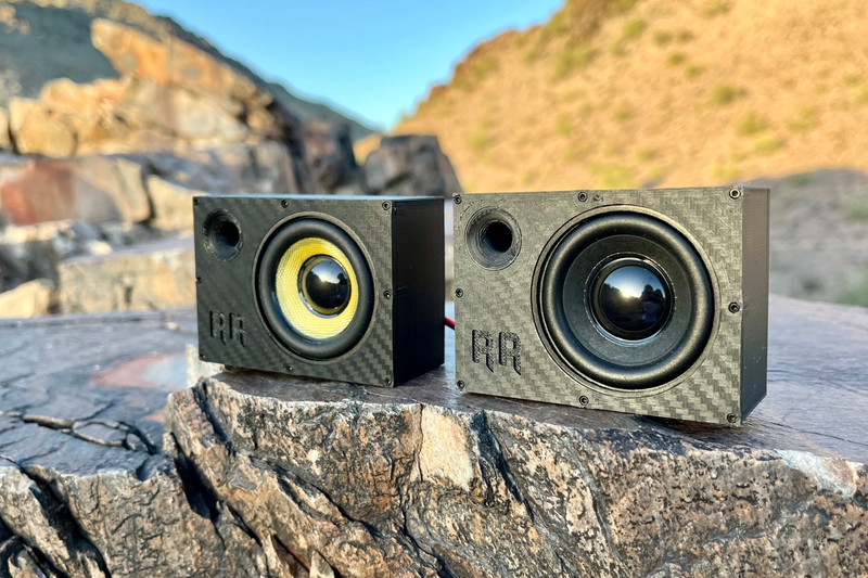 Two Supreme Single units side by side on rock, one with a yellow cone and one with a black cone. 1/10 scale.