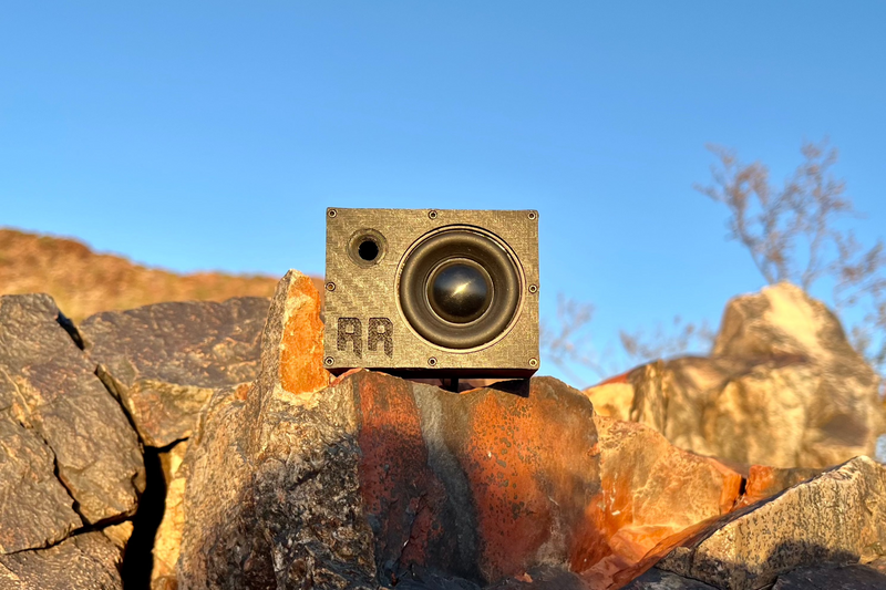 The Super Single on a rock edge against clear blue sky, yellow cone and port in full view. 1/10 scale.