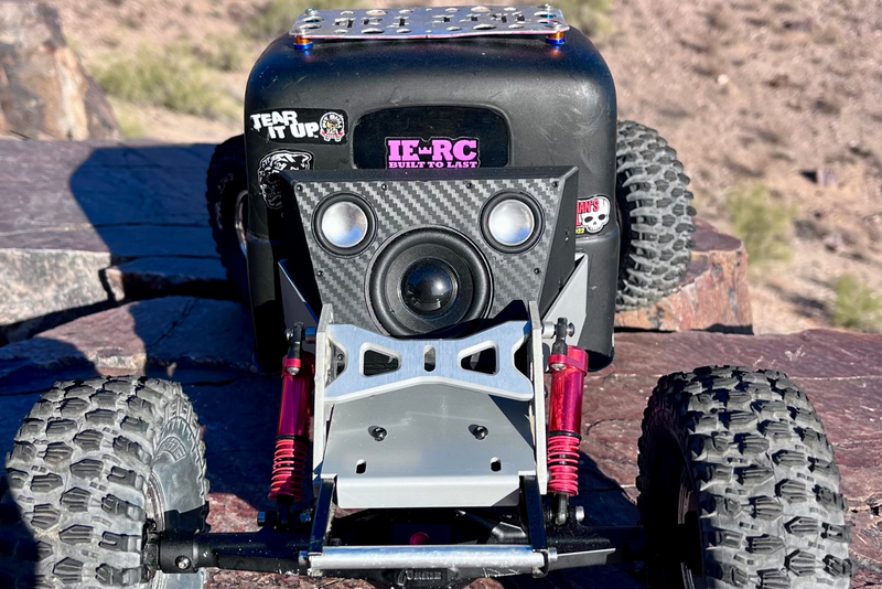 The Overkill for Hardline Bed mounted on the front end of a black comp crawler on rock. 1/10 scale.