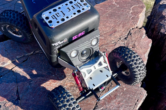 Close-up of The Overkill for Hardline Bed fitted to the front of a black comp crawler above the skid plate. 1/10 scale.