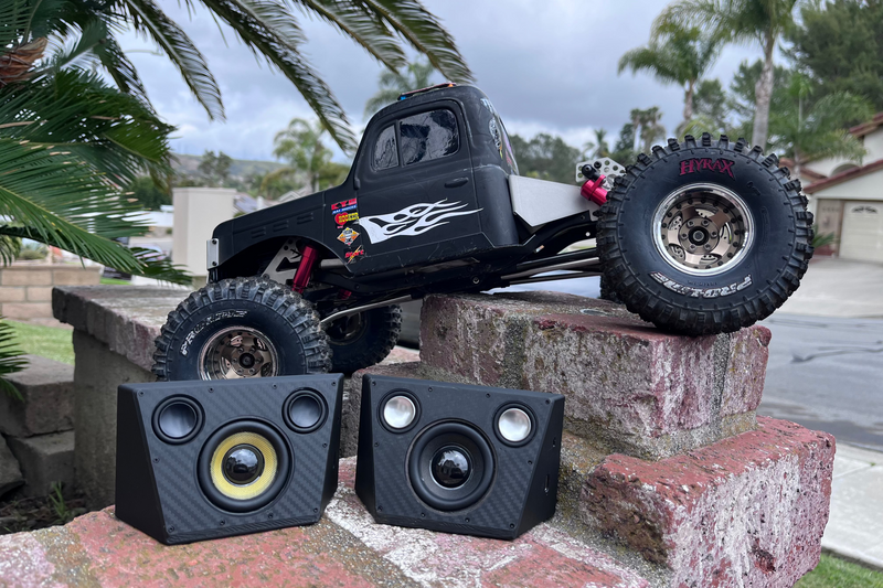 Two Overkill for Hardline Bed units on a brick ledge in front of a black RC crawler with flame graphics. 1/10 scale.